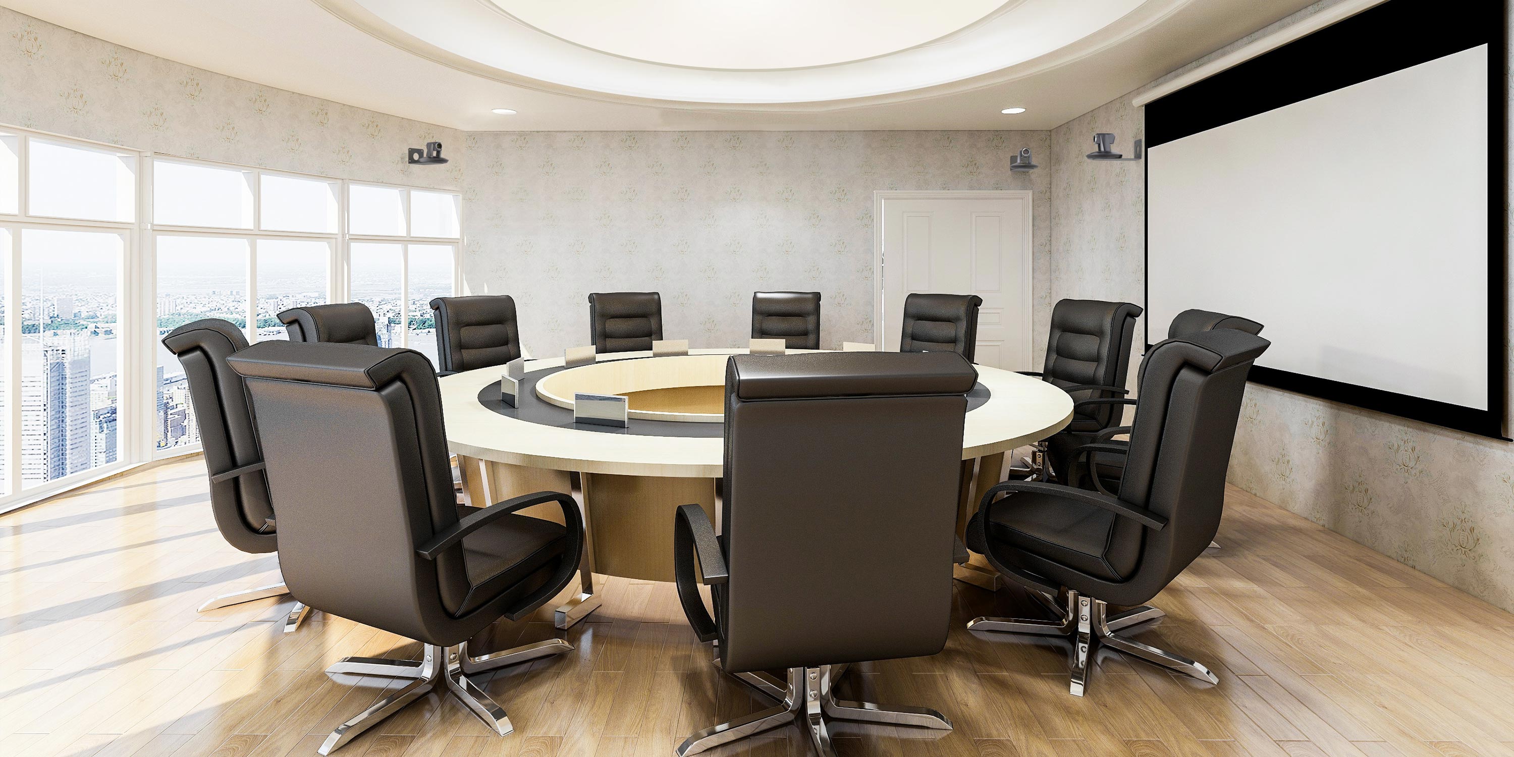 Circular meeting table with black chairs in a bright office space