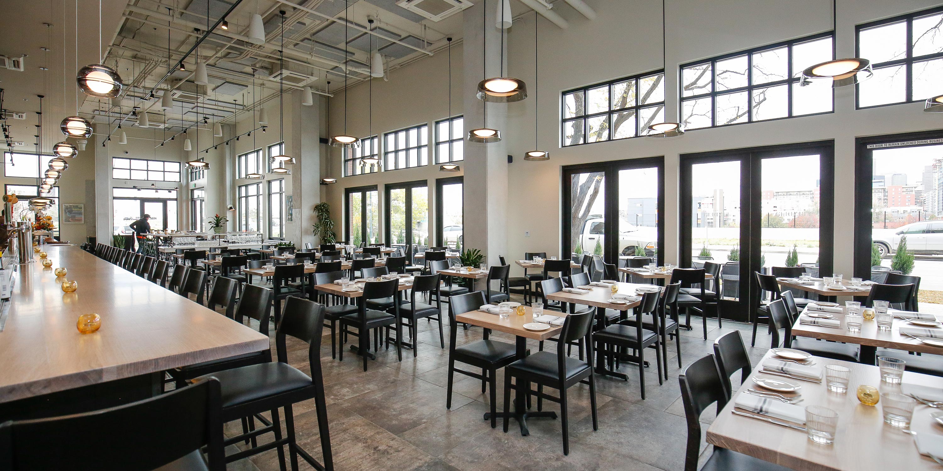 Contemporary restaurant interior with bar seating and dining tables