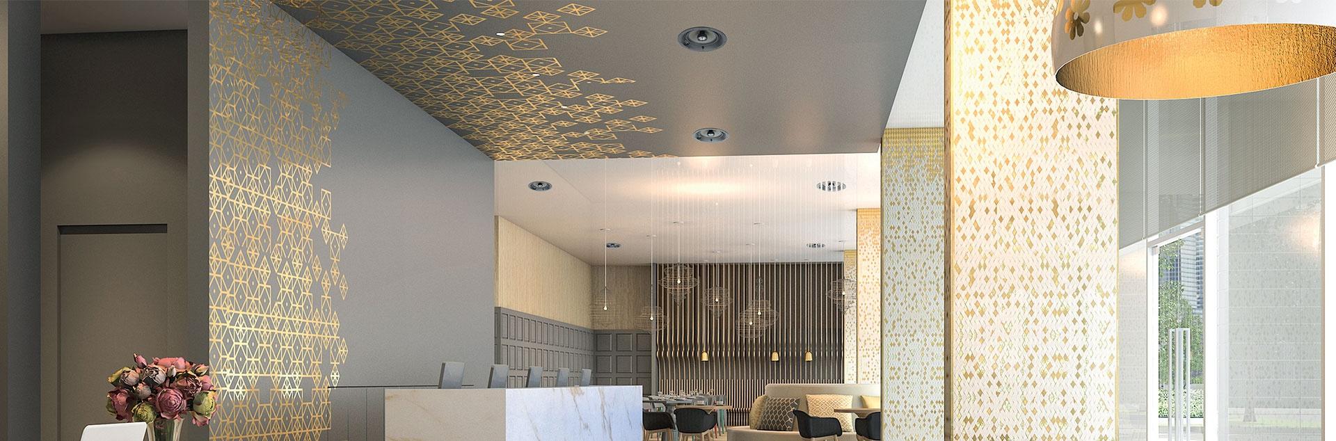 Elegant hotel-style lobby with decorative ceiling speakers and gold accents