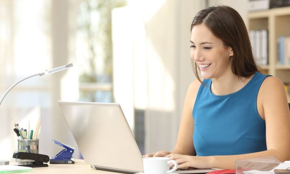 <span class="uk-h4">A woman at her desk and computer in her home office, utilizing her home network.</span>