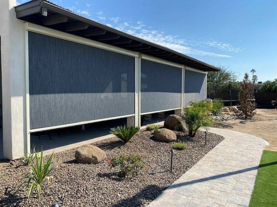 Outdoor view of a patio with Progressive Screens motorized patio shades.