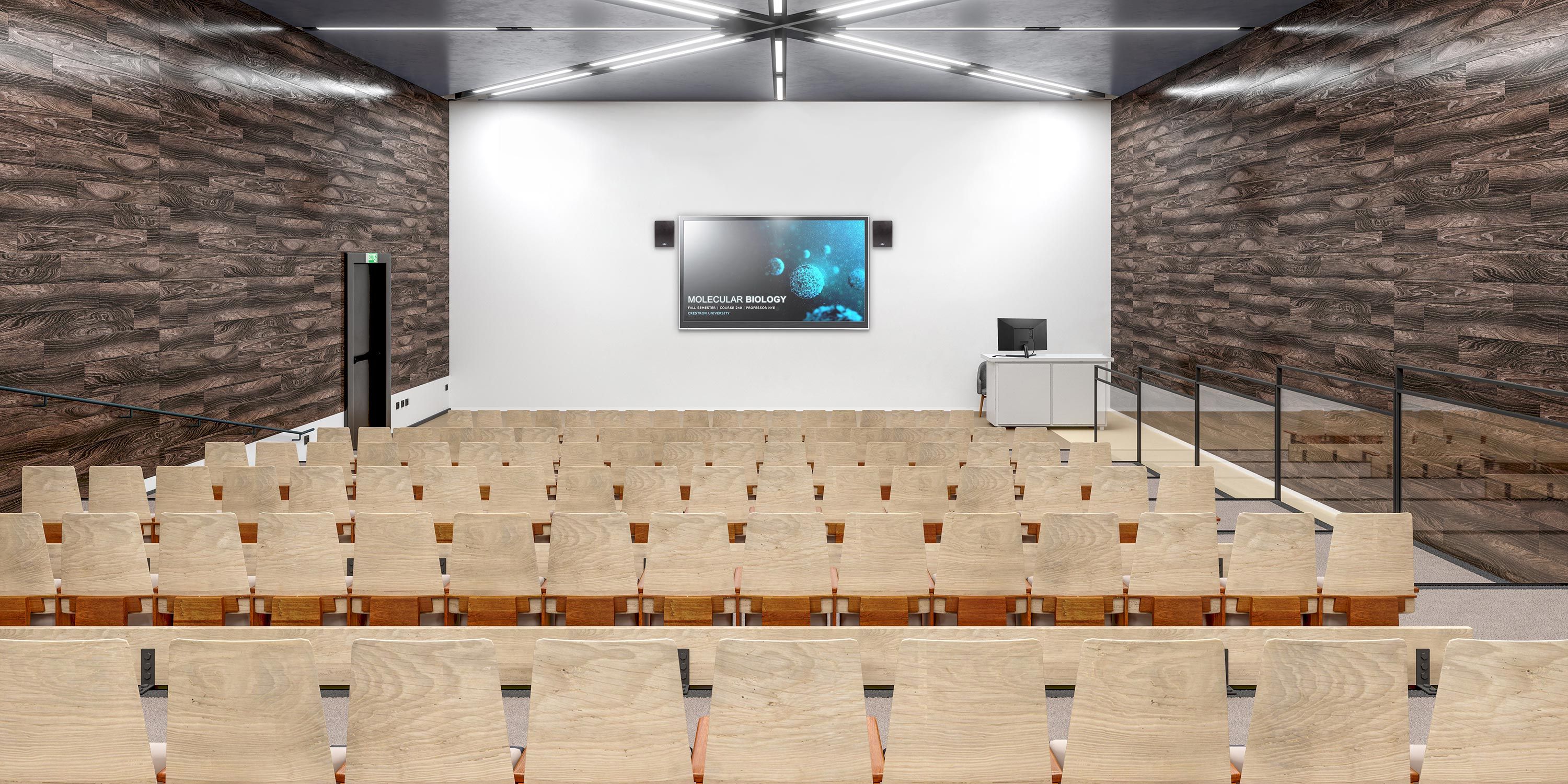Empty lecture hall with wooden chairs and a large screen at front