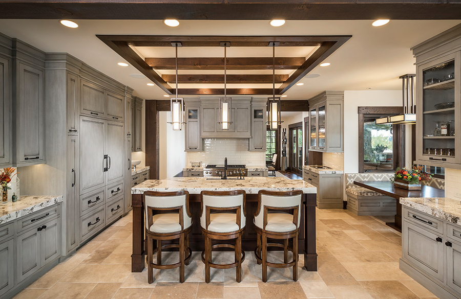 DMF Lighting in-ceiling and pendant fixtures in a large kitchen area with gray cabinets.